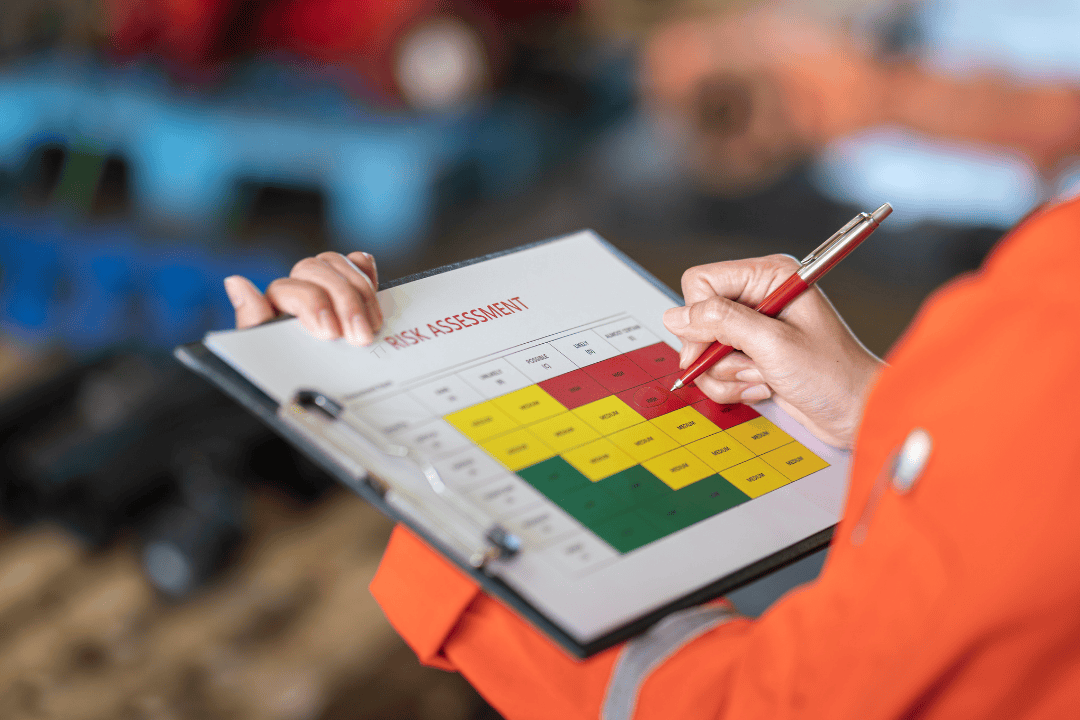 person holding clipboard with risk assessment