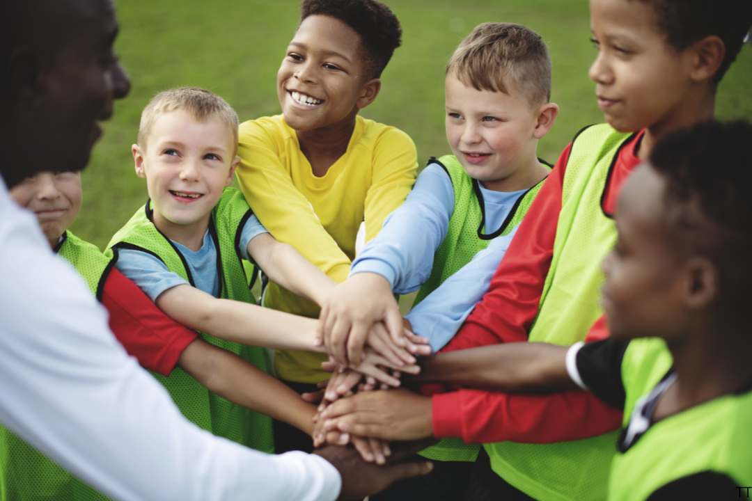 children with their hands in the centre of the photo